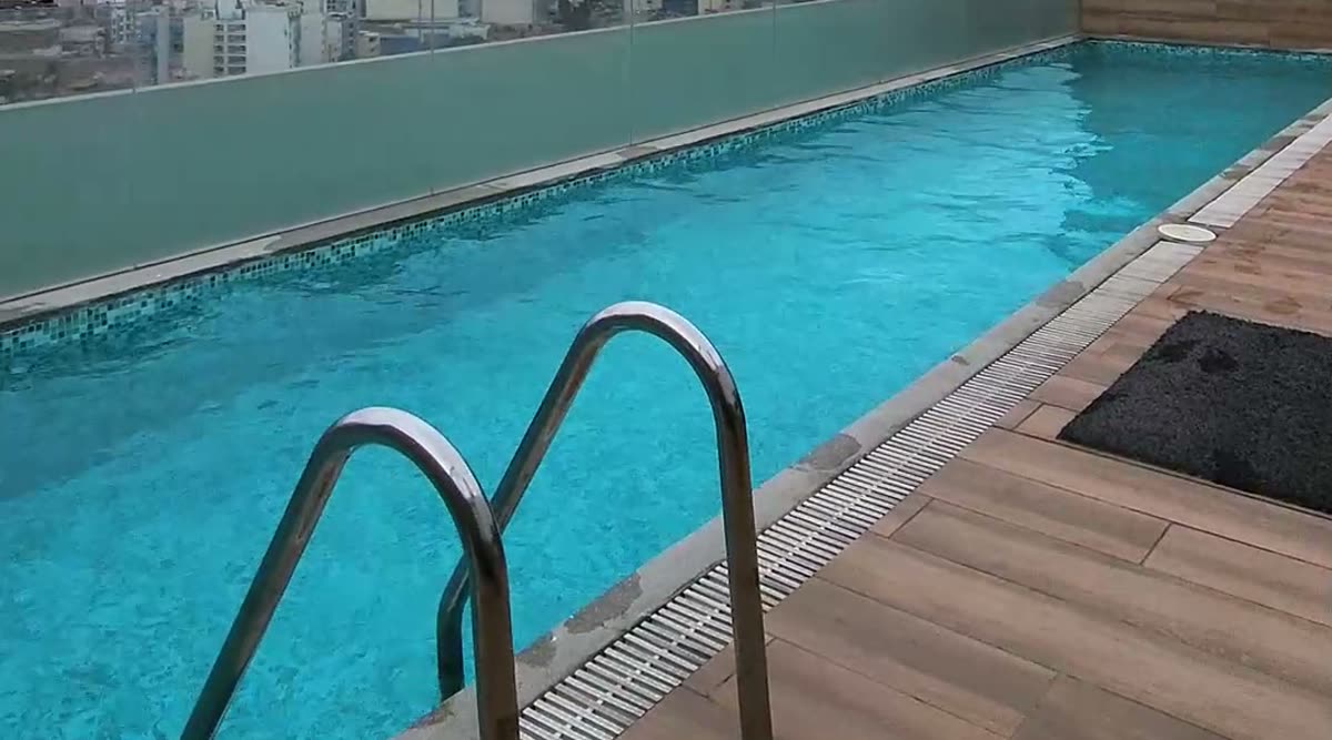 Terraza con piscina del edificio, con vista a Lima